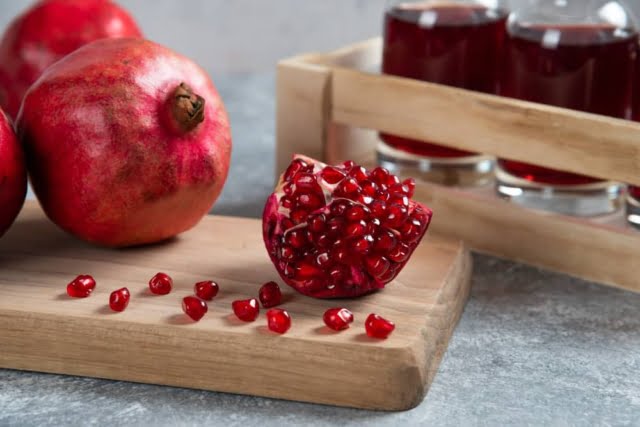 10 Foods to Cure Erectile Dysfunction Permanently 11 fresh red pomegranates wooden board with juice