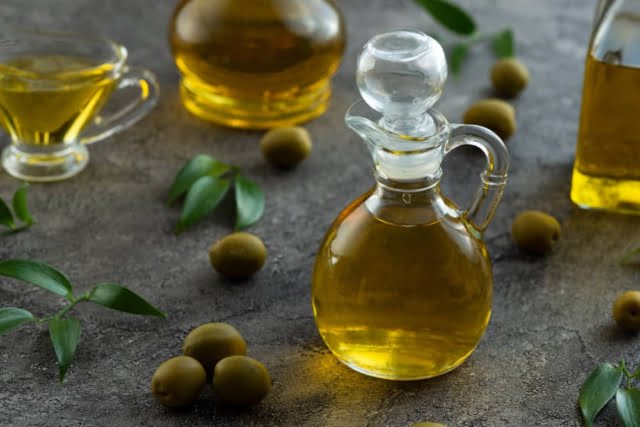 10 Foods to Cure Erectile Dysfunction Permanently 8 high view bottles filled with olive oil marble background